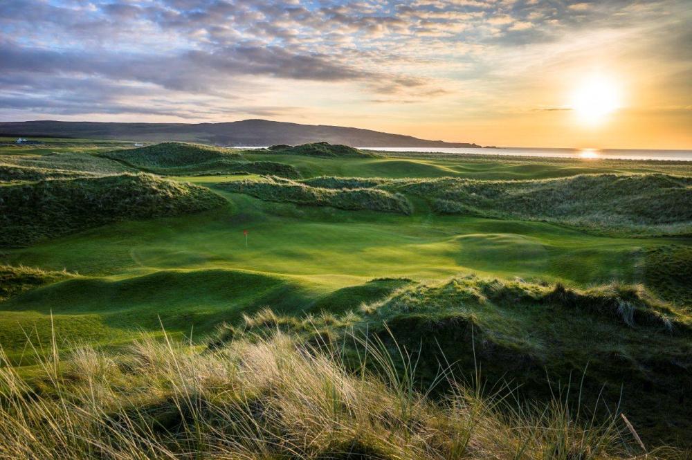 Sunset behind Machrie's green