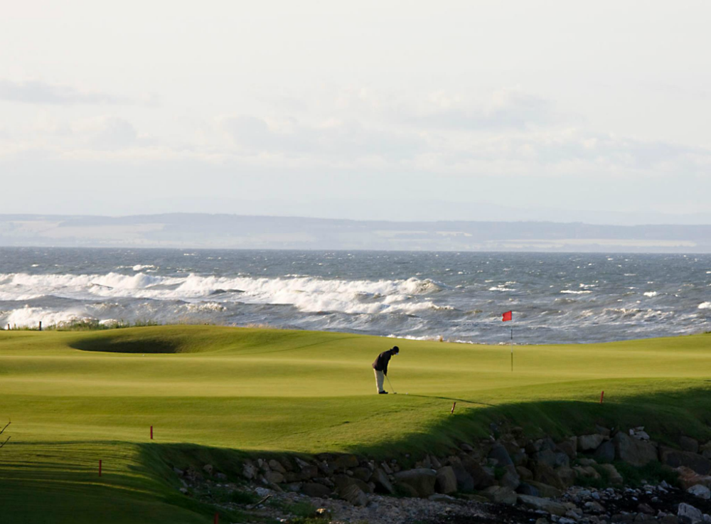 A golfer playing on the 15th green at kingsbarns 