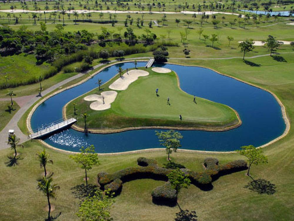Players playing on the Island green at the Damha golf course