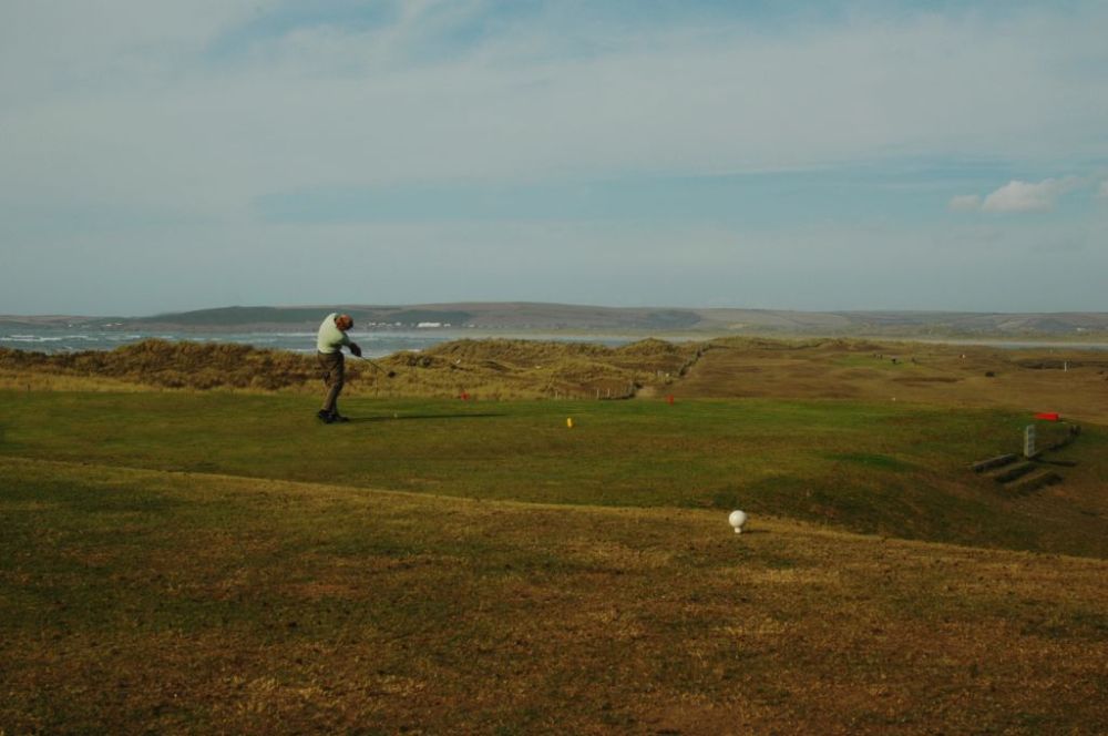 Golfer on a tee at Royal North Devon golf course