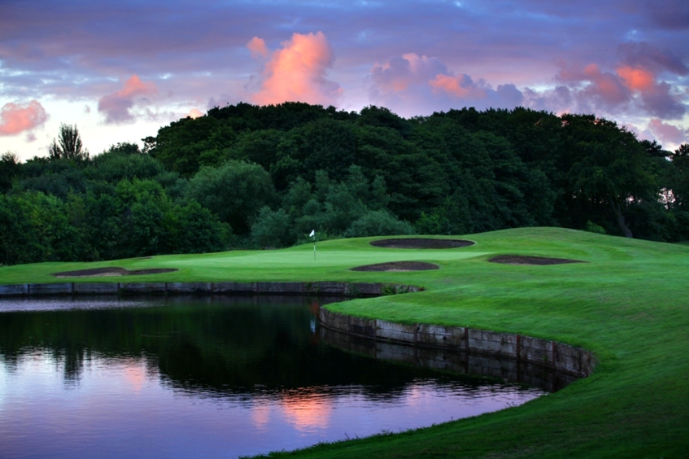 Green guarded by water and bunkers on the Formby hall golf course