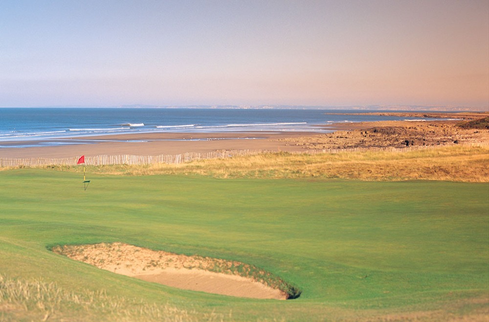 Large green and beach on the Royal Porthcawl golf course