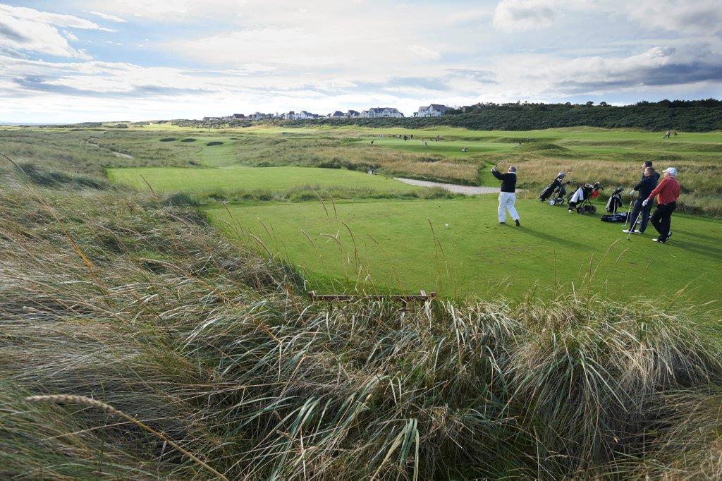 Golfers playing at Royal Dornoch during the Tomatin Pro Am
