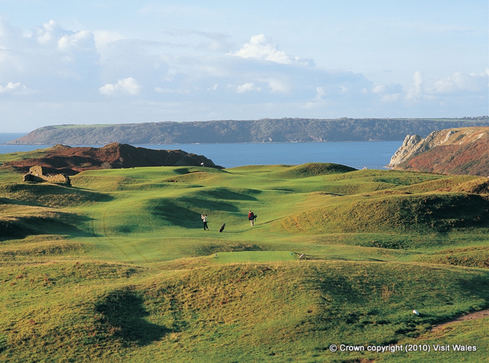 Golfers playing on an undulated fairway at Pennard