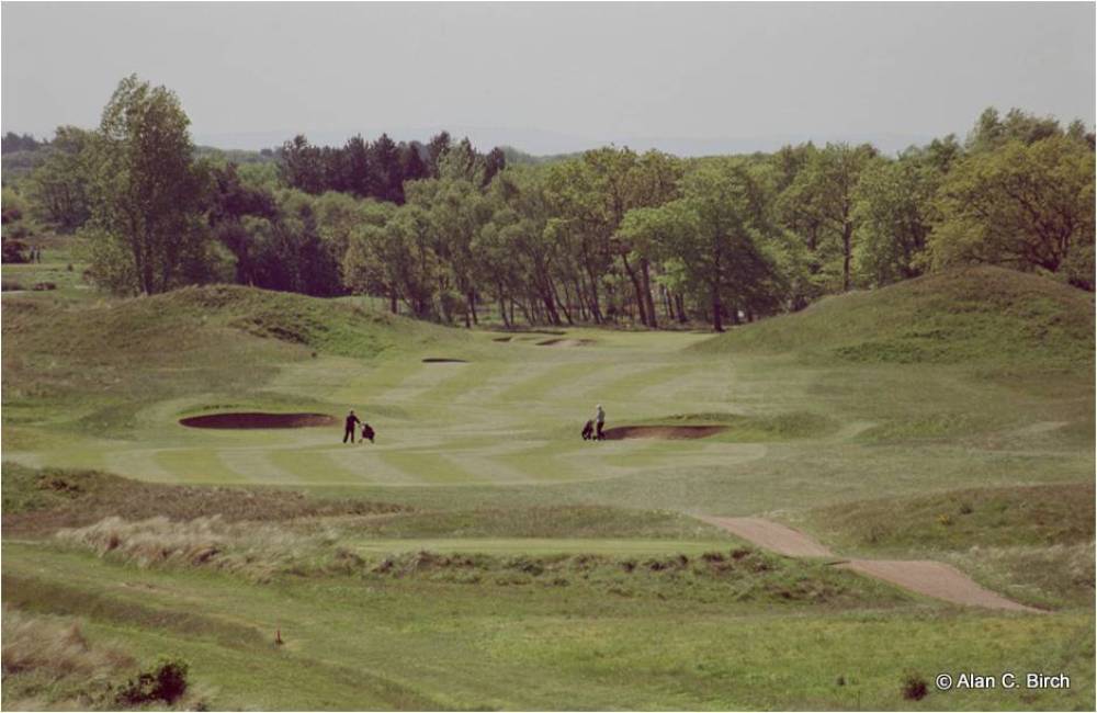 Golfers on a dogleg right hole on the Hillside golf course