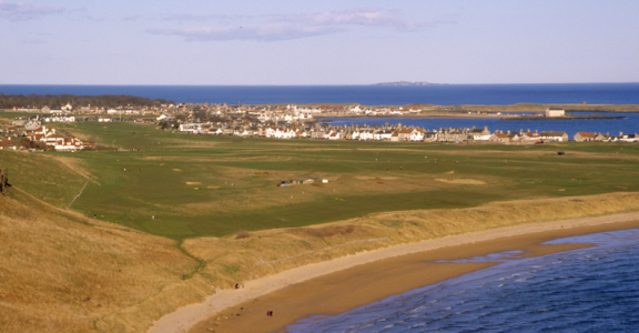 Town behind golf course at at Elie Golf Club