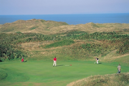 Golfers playing on Pyle and Kenfig golf course