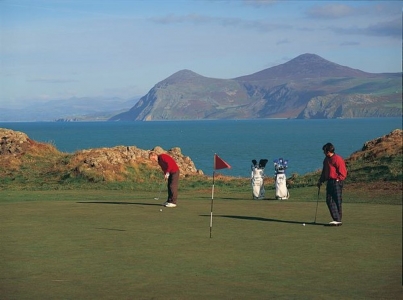 Golfers putting on Nefyn and District golf course