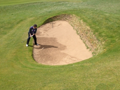 A golfer in a scottish bunker at Prestwick golf course
