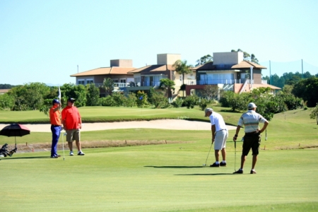 Golfers putting at the Costao Golf Club at Florianopolis