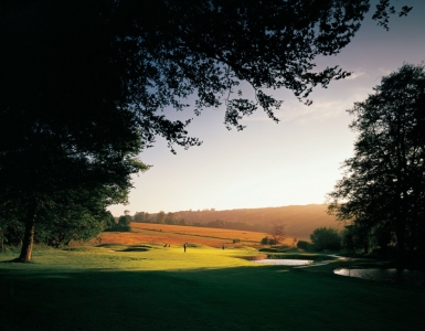 Golfers putting on a green at Goodwood golf course