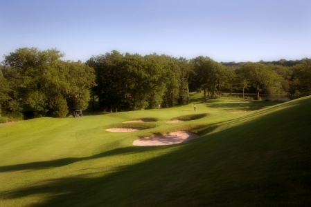 Golfers putting on the Lake Course at the Vale resort