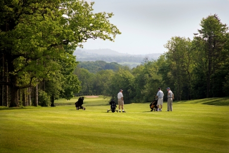 Golfers playing on the Wales National course at the Vale resort