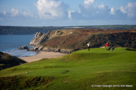 Spectacular views from a tee with golfers at Pennard