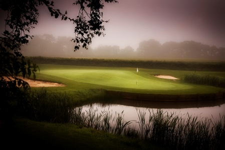 Undulated green and lake on the Wales National course at the Vale resort