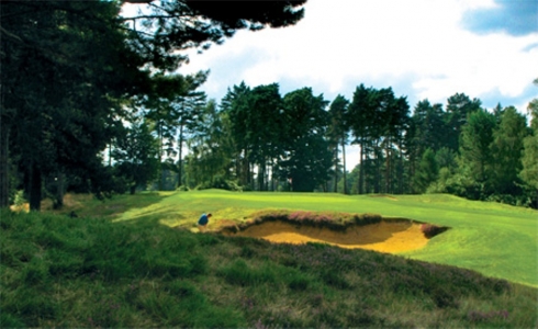 Golfer playing a bunker shot on the red course at The Berkshire Golf Club