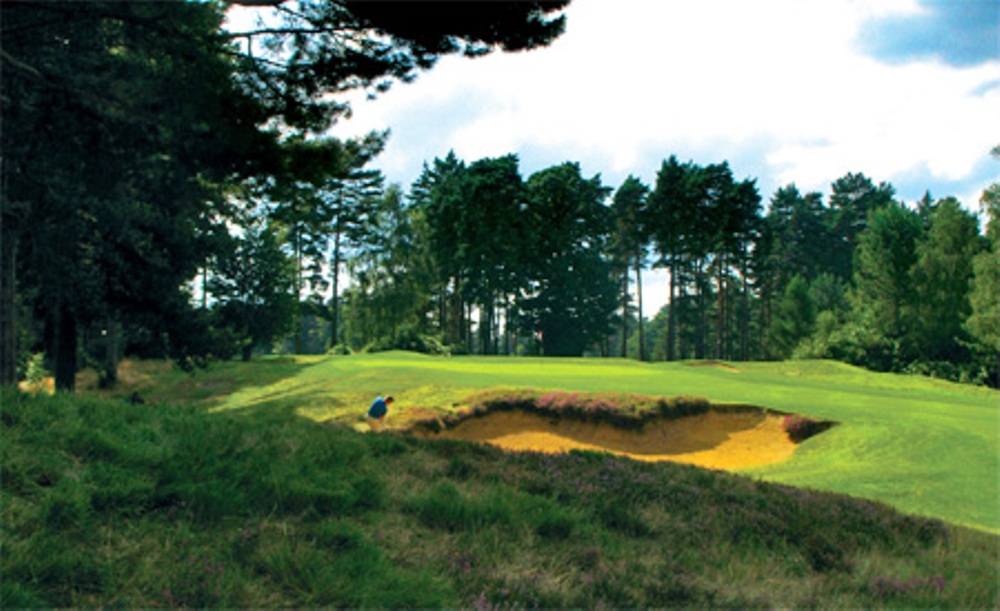 Golfer playing a bunker shot on the red course at The Berkshire Golf Club